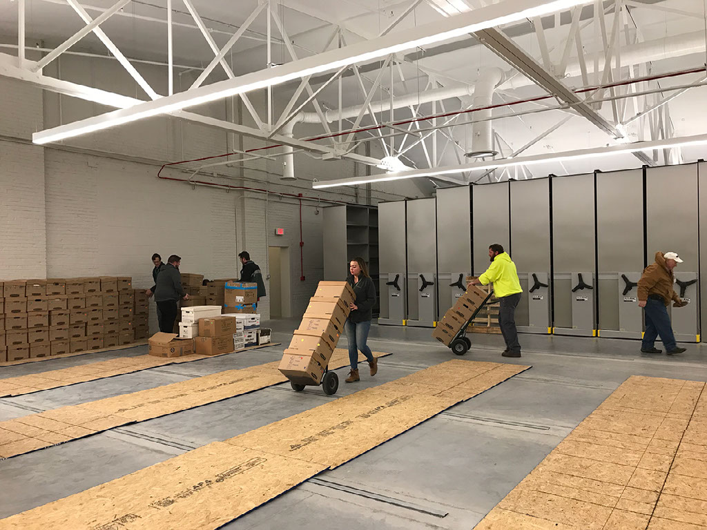Moving boxes of files into the finished facility on December 2019 – Archives Facility Storage