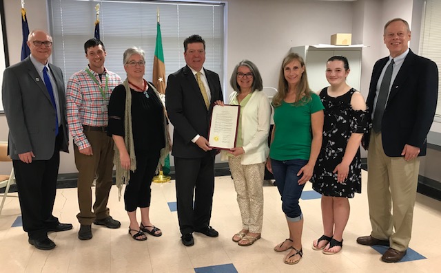 The Board of Commissioners stand with the Chambersburg Lyme Alliance to present a Lyme Disease Awareness Month proclamation.