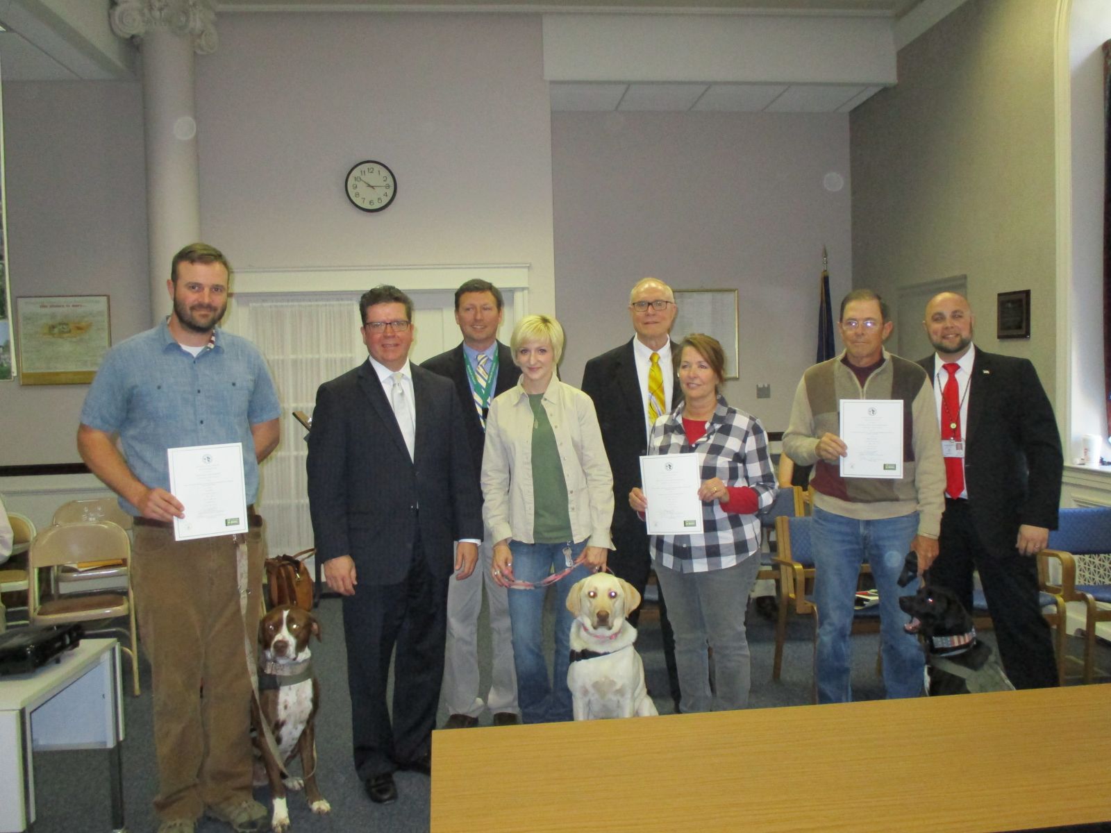 Pictured L to R are:    Alex Reed with Turk; Chairman David Keller; John McPaul, VA Community Outreach & Events Coordinator; Kami Emerick, Trainer with Skyler, Commissioner Robert Thomas; Helen Carlson, Dog Trainer; Ken Hadley with Jango; and Justin Slep, VA Director.