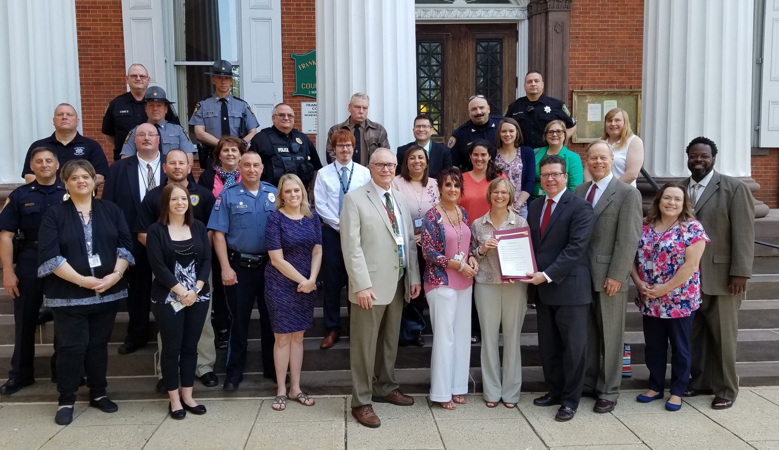 Representatives from local and state law enforcement, Franklin County government and community agencies join together to recognize May 8, 2018 as Franklin County Stepping Up Day of Action.