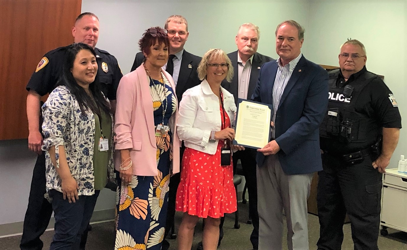 Congressman John Joyce, M.D. presents Cori Seilhamer with the Extension of Remarks surrounded by Law enforcement and mental health professionals 