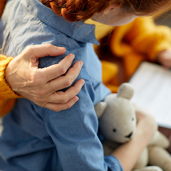 Closeup of unrecognizable woman hugging teenage girl with care and love,