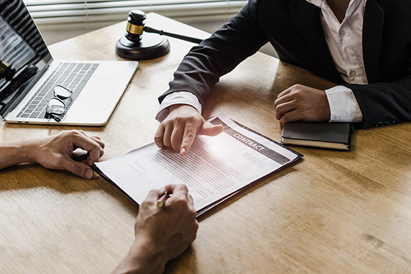 Two people looking over a contract.