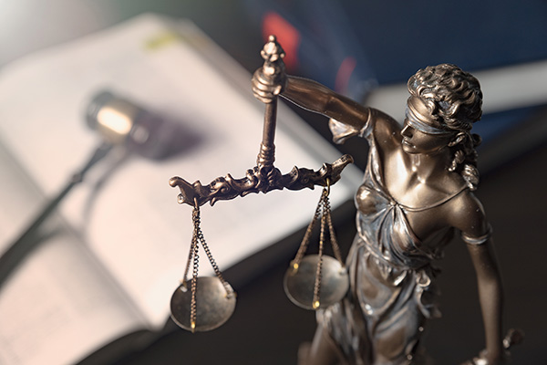 The scales of justice held aloft by lady justice.