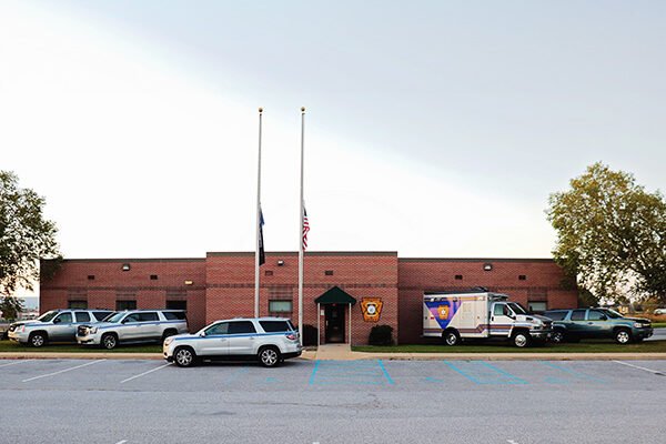 The exterior of the the coroner building and vehicle fleet.