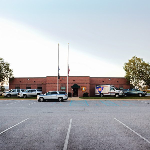 The exterior of the the coroner building and vehicle fleet.