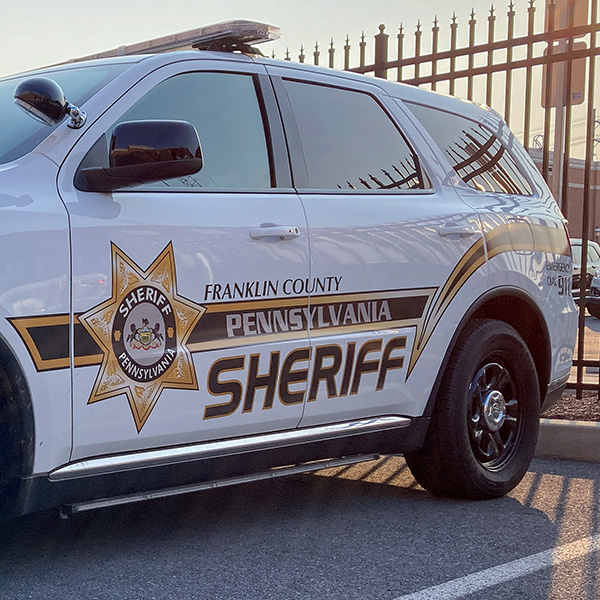 The Sheriff logo on a sheriff vehicle in a parking lot