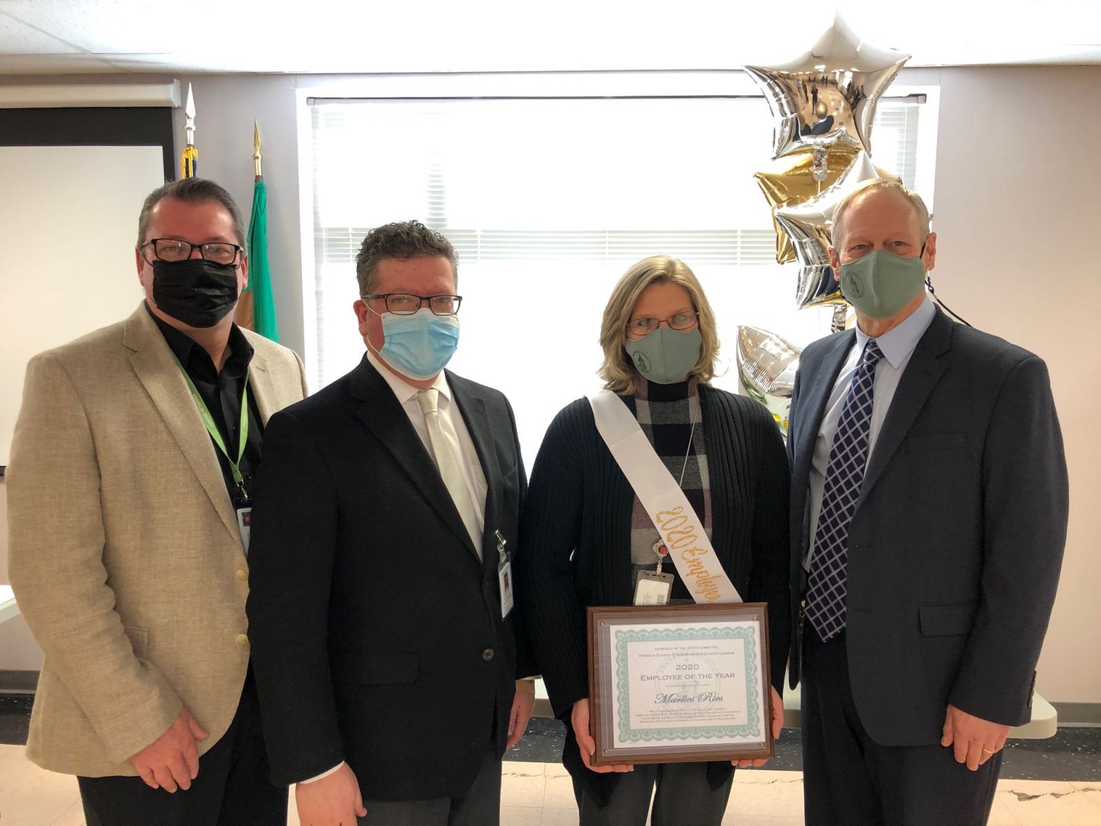 Pictured above (left to right): Commissioner John Flannery, Commissioner Chairman Dave Keller, 2020 Employee of the Year - AIS/Accounting Manager Marlies Ries, and Commissioner Bob Ziobrowski