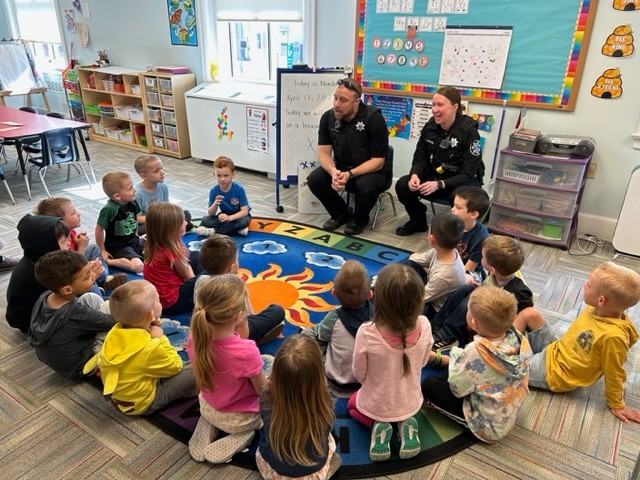 sheriff deputies talking to a group of small children