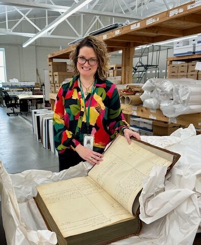 Stefanie Basalik, Franklin County Archives & Records Management Director with a huge old book